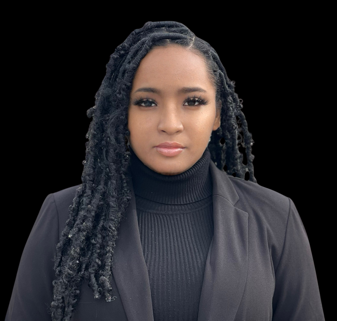 Woman wearing a dark blazer over a black turtleneck with a leopard print skirt on a black background